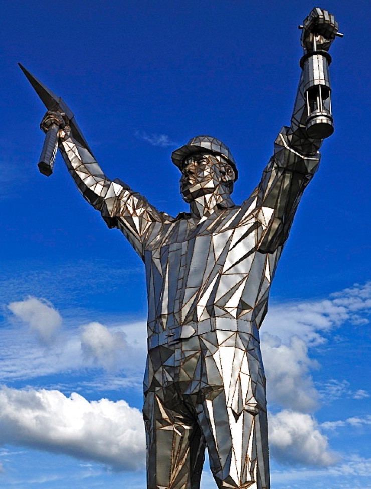 Jigger, the Brownhills Miner statue, pick and lamp raised against the sky